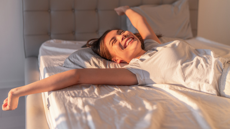 woman stretching in bed