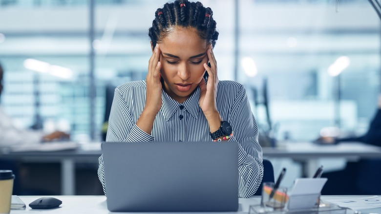 Stressed woman holding her temples