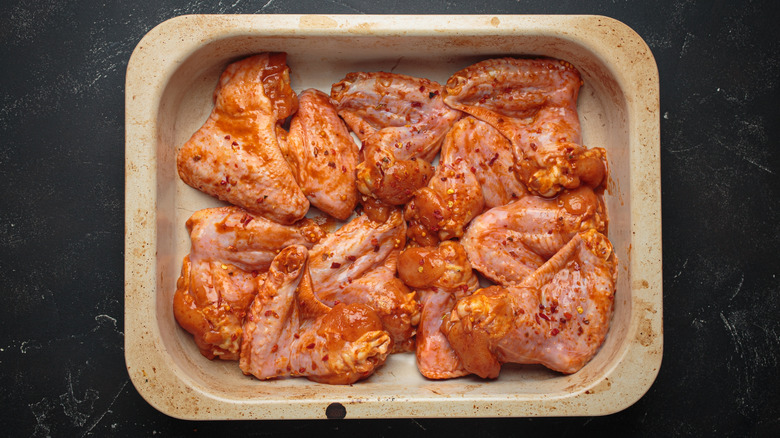 Chicken marinating in a dish