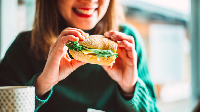 Woman eating sandwich