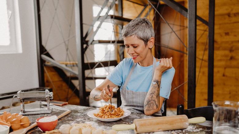 woman eating fresh pasta