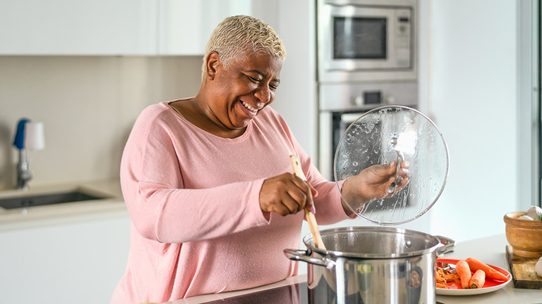 woman cooking pasta in large pot
