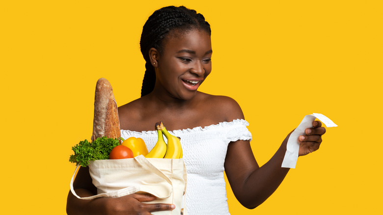 woman holding food and receipt