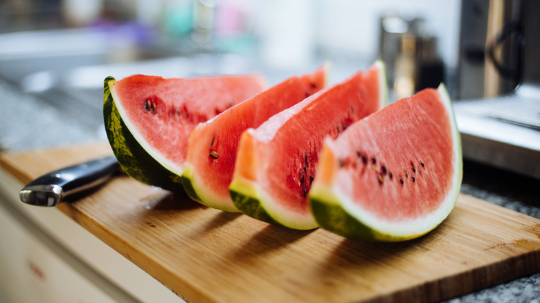 Smiling man eating watermelon slice