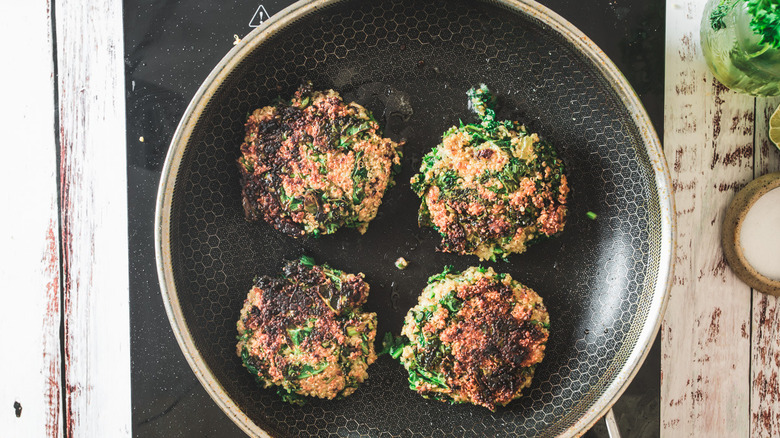 quinoa cakes frying in pan