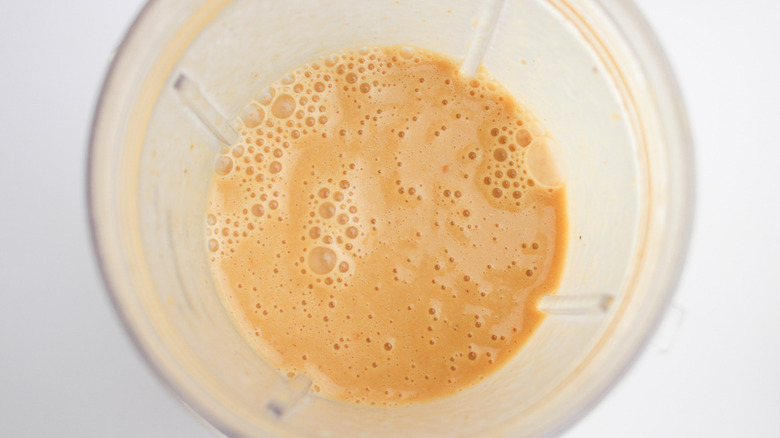 orange smoothie in blender