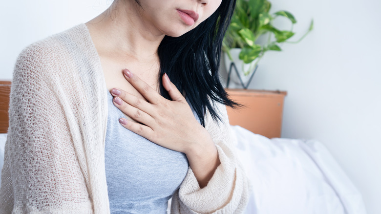 woman with hand on chest