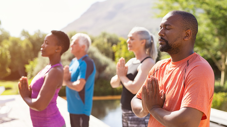 group of adults doing yoga 