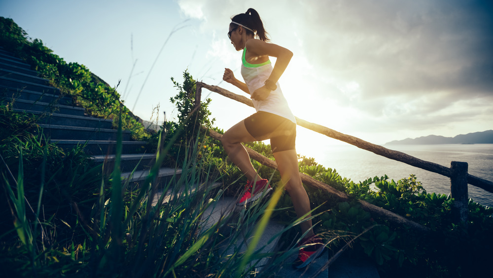 Stock photo of a woman climbing stairs outdoors