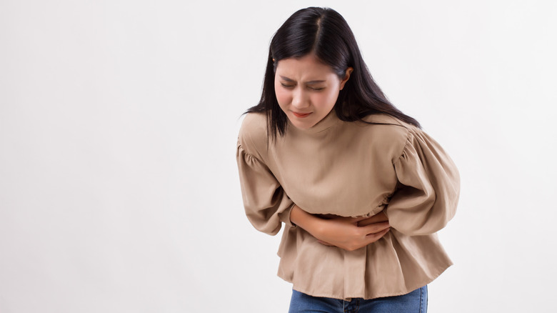 Woman holding her stomach in pain