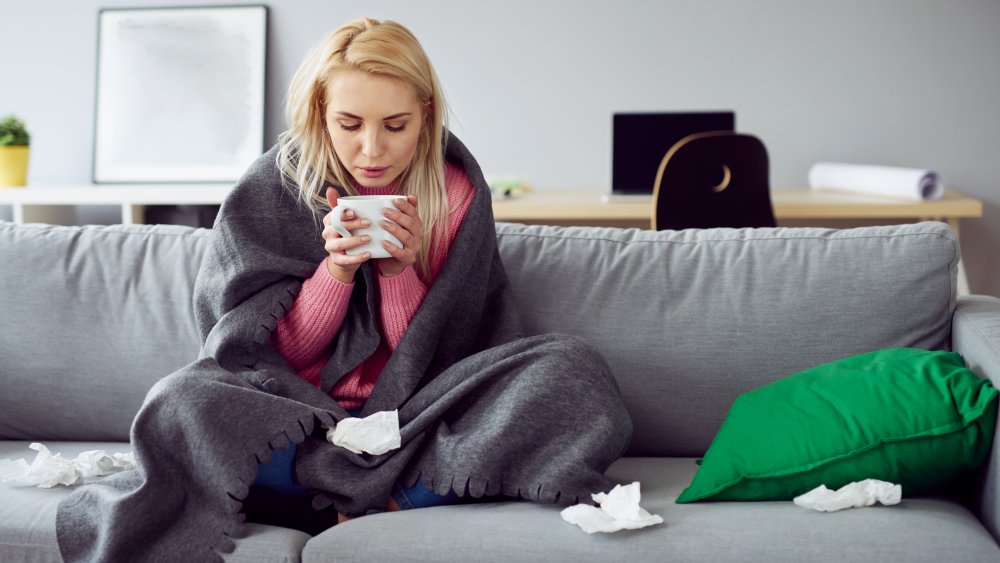 woman on couch drinking tea
