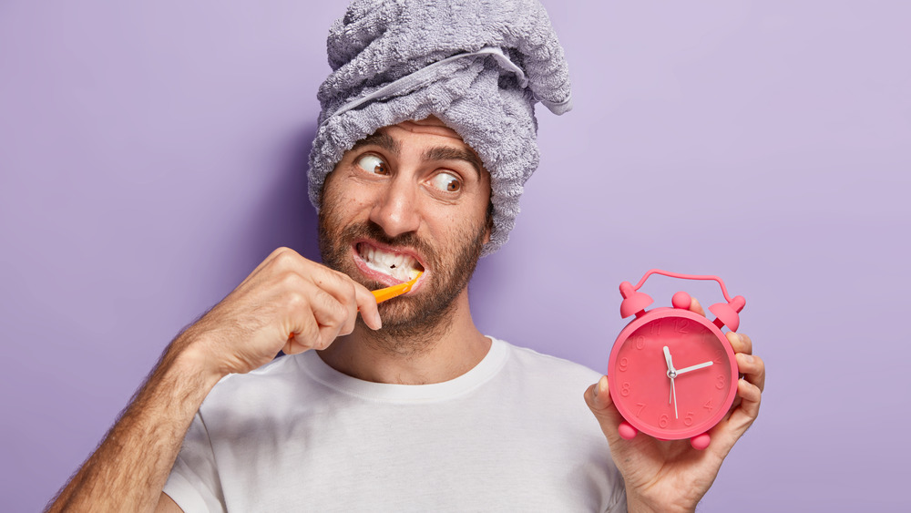 Man brushing teeth with timer