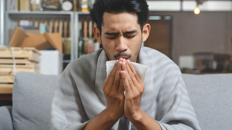 man sneezing