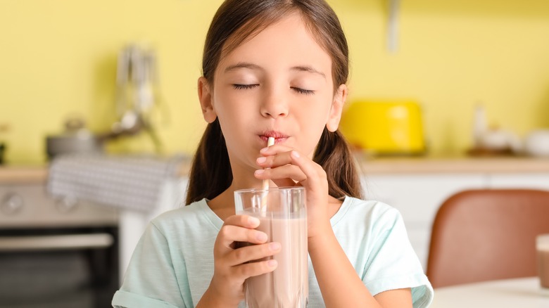 little girl drinking chocolate milk