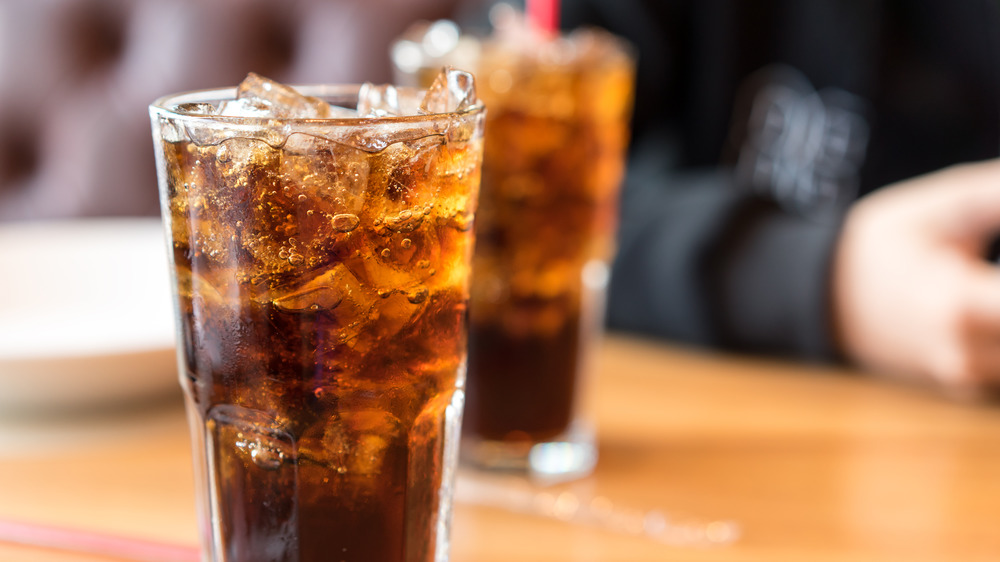 Two glasses of soda on a table