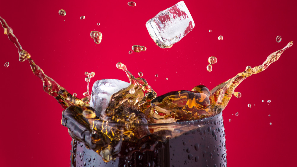 Ice cubes splashing into a soft drink