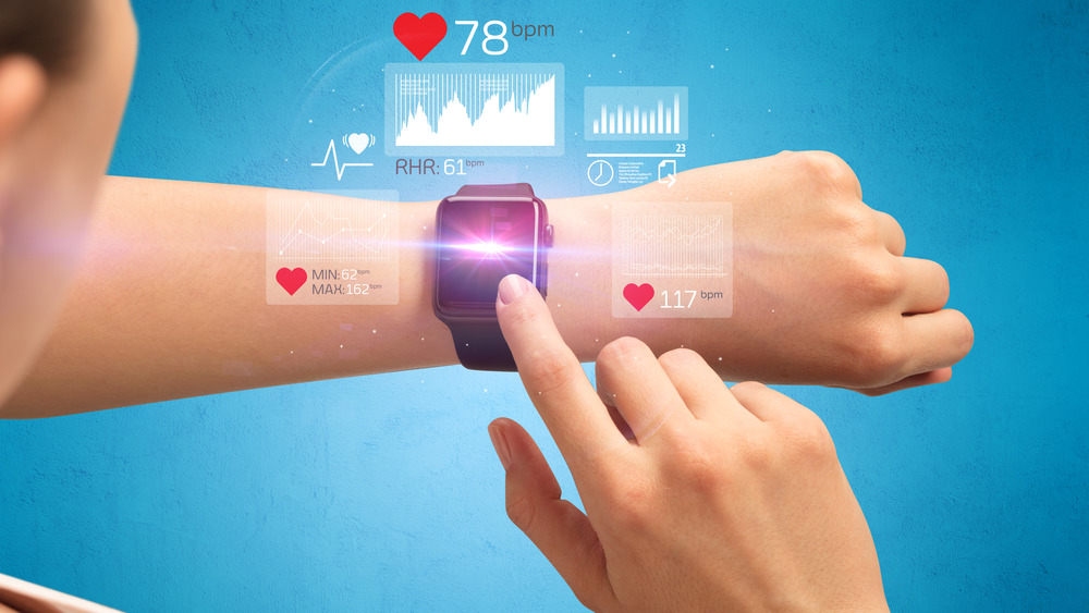 Woman checking smart watch with BPM