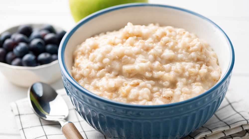 bowl of oatmeal with berries on the side