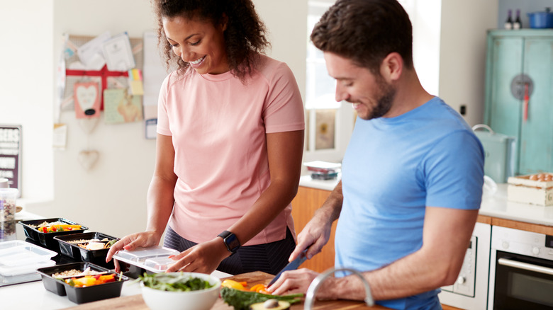 a couple fixing healthy meals