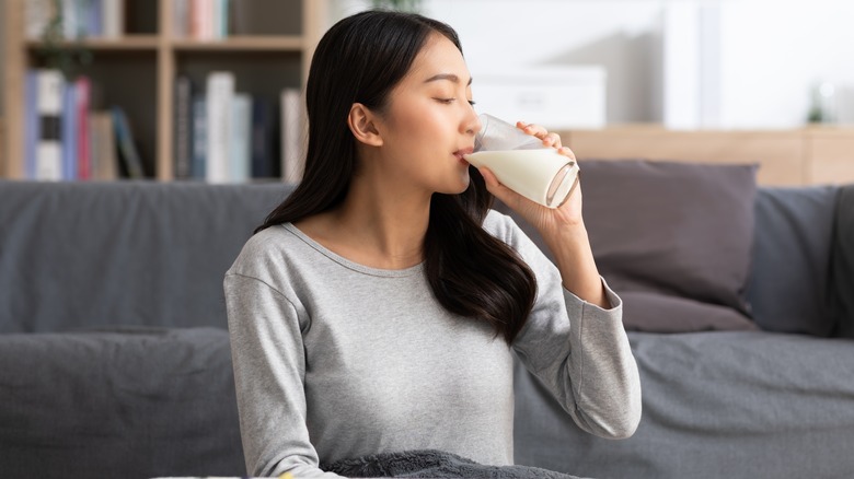 Woman drinking a glass of milk