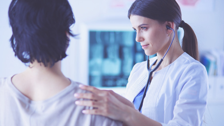 doctor listening to patient's heart