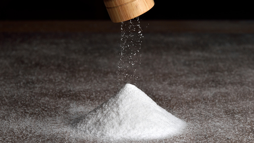 Wooden salt grinder and salt pile