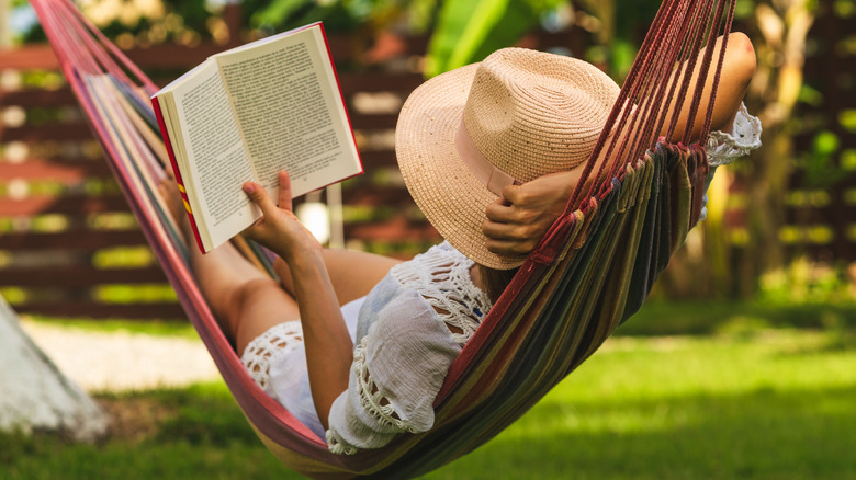 woman in hammock reading book
