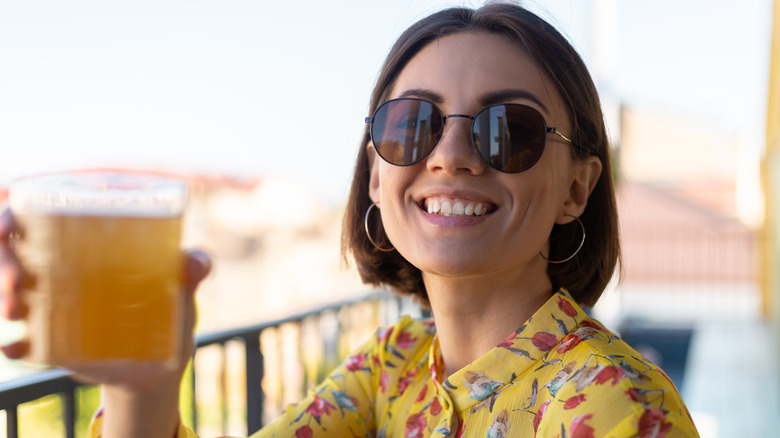 a woman smiling with kombucha