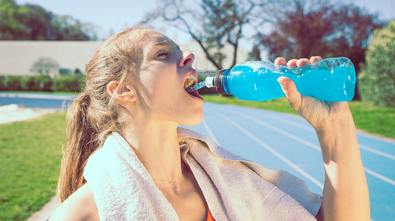 woman consuming sports drink
