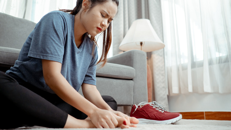 Concerned woman looking at feet