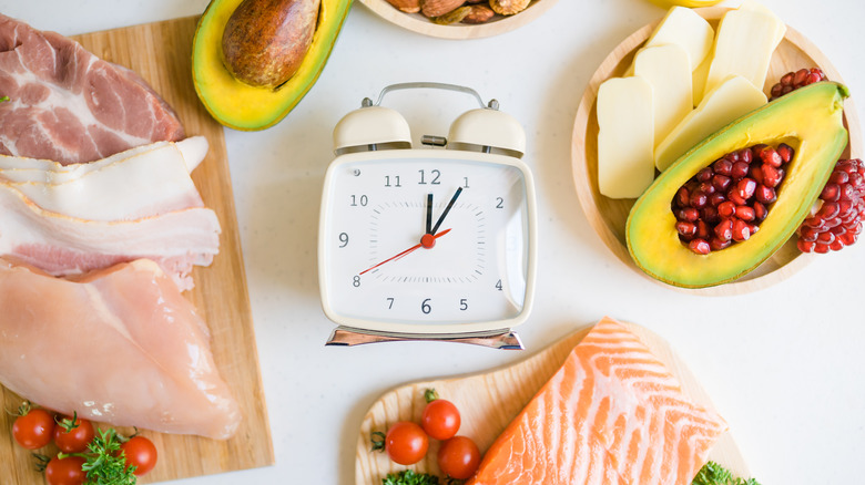 a clock surrounded by healthy foods 