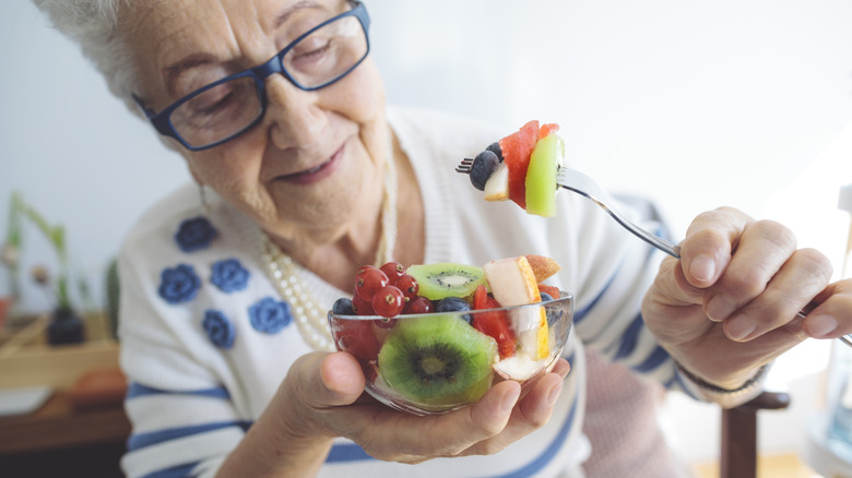 older lady eating fruit bowl