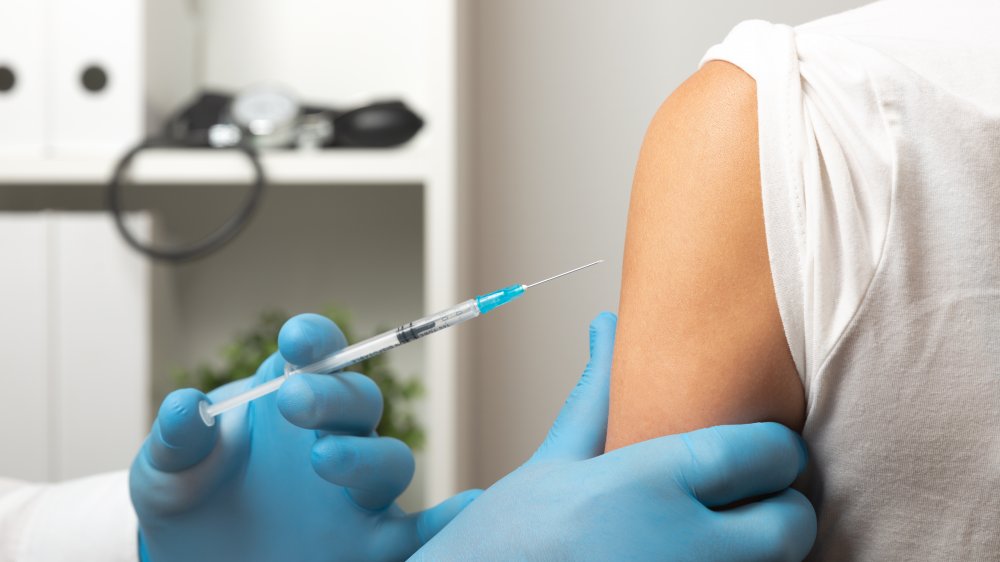 Doctor giving vaccine injection in arm