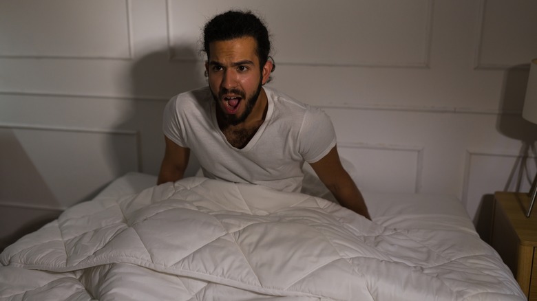 Man waking up scared