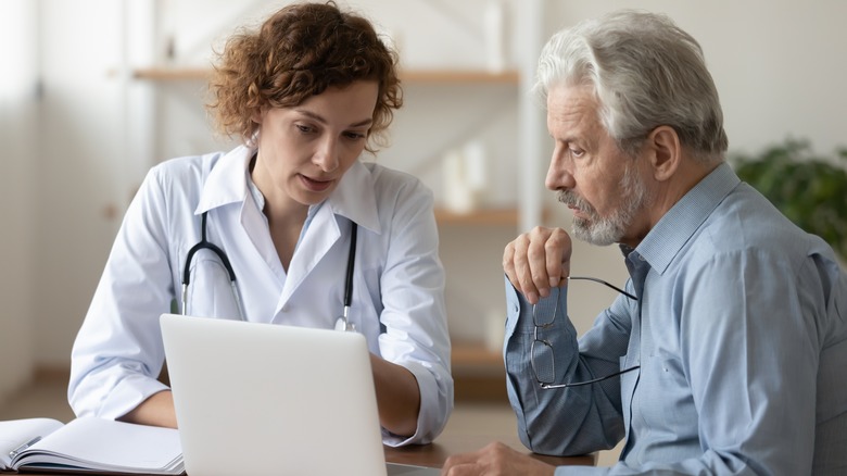 older man consulting with doctor