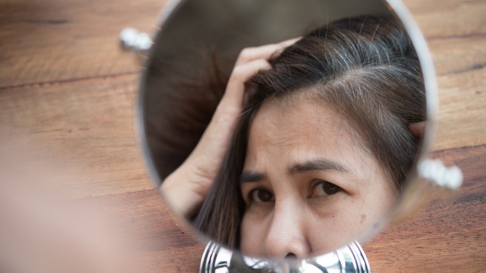 Stressed woman with gray hair