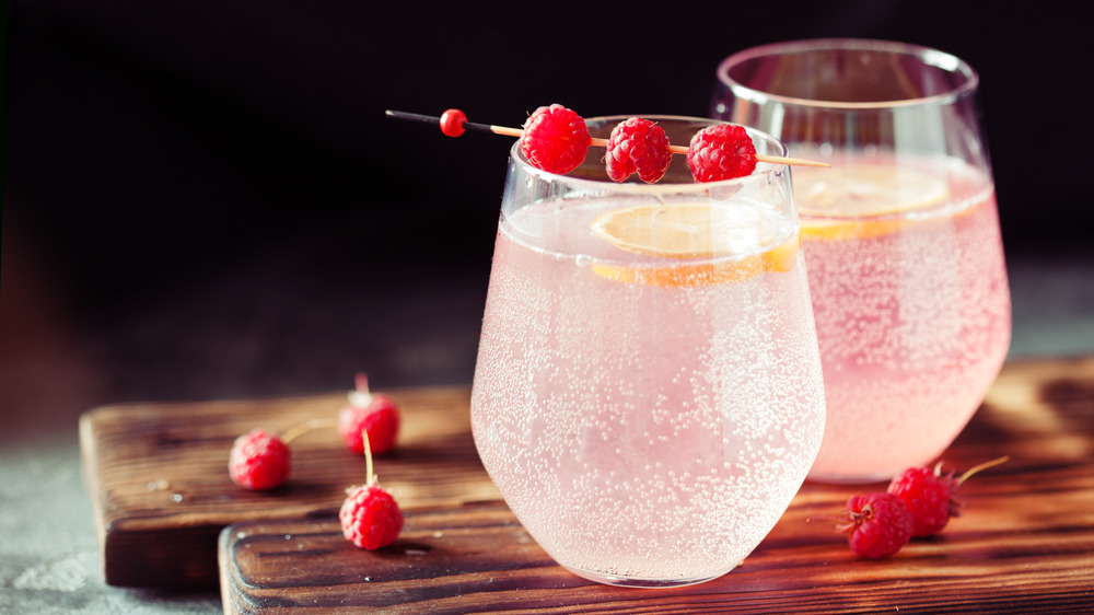 Sparkling pink raspberry lemonade on dark background