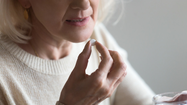 woman taking pill