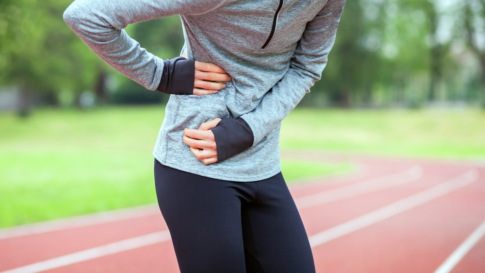 Runner experiencing a side stitch.