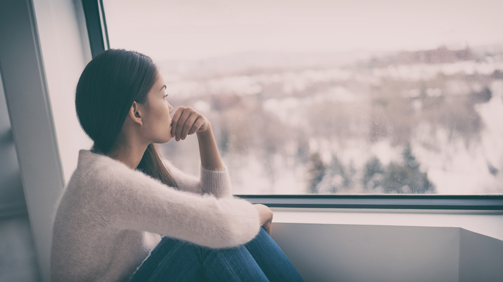 Woman looking out a window