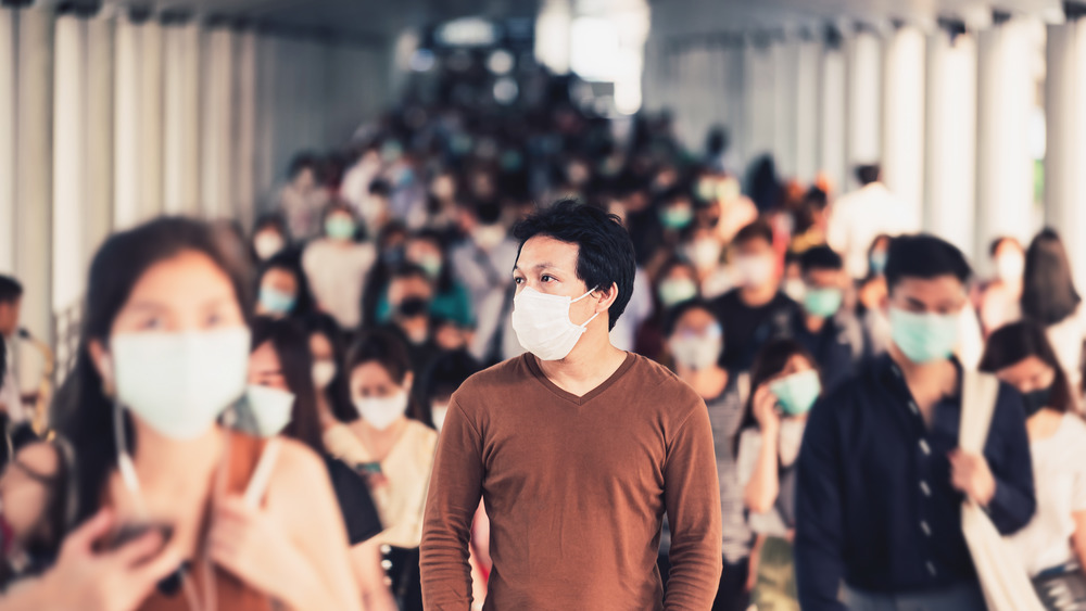 Group of people walking in masks