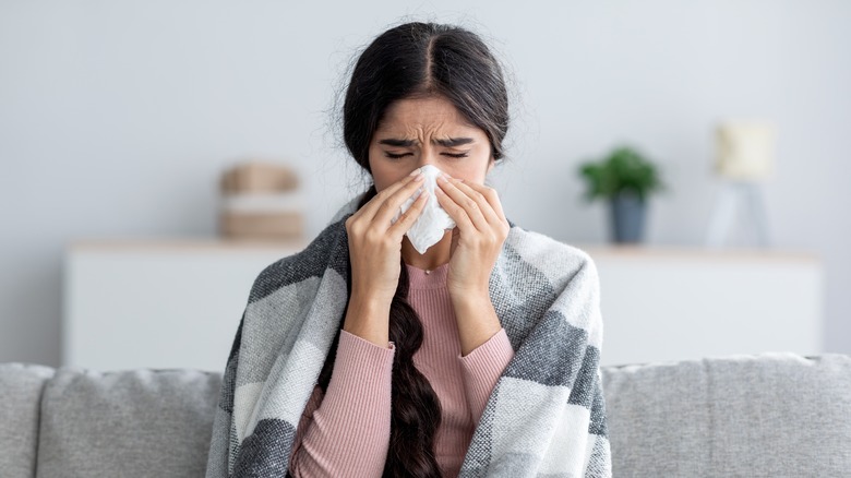 A woman is at home sick