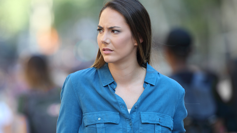 woman outside appearing concerned and perplexed