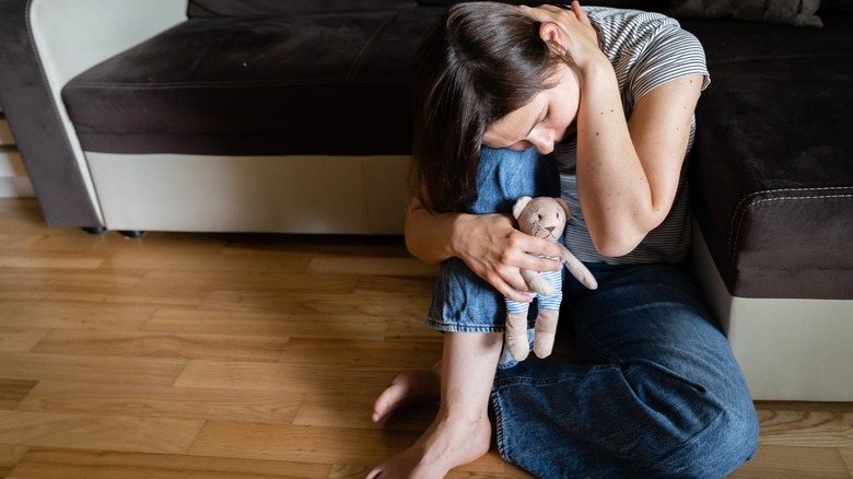 woman holding toy in memory of baby