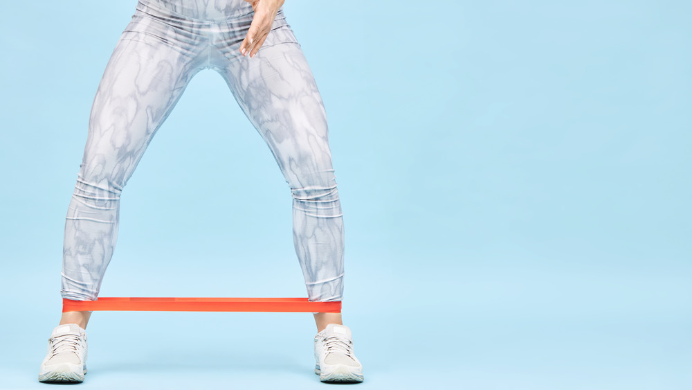 Woman using resistance band