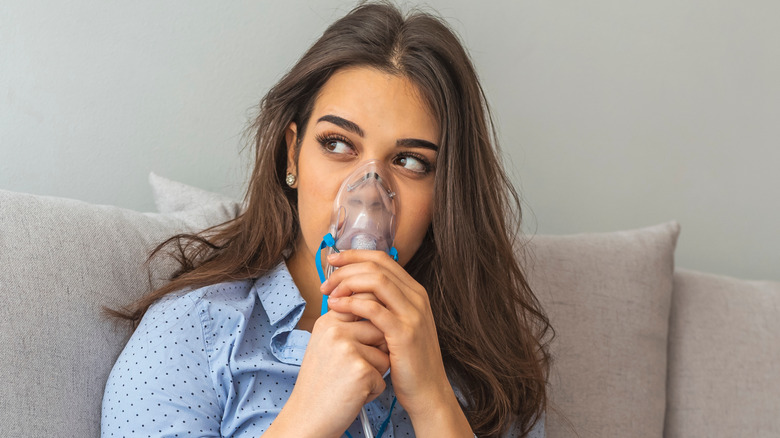 Women with nebulizer on face