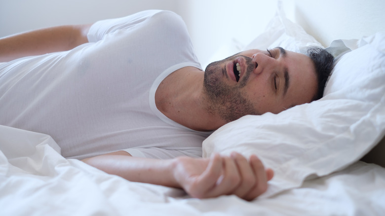 Man snoring in bed