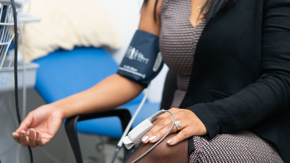 Woman having blood pressure taken