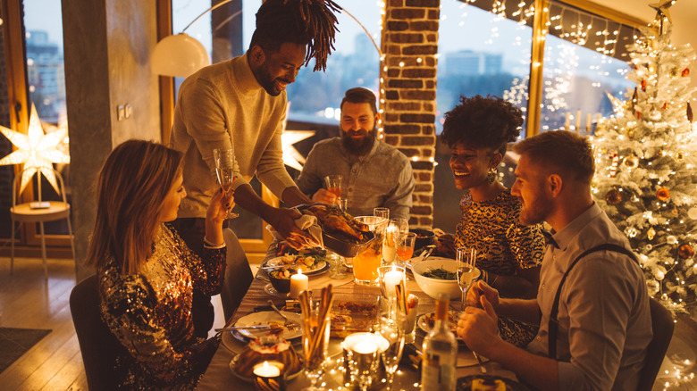 group of friends gathered around a holiday table