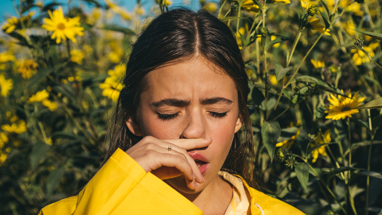 Woman holding a sneeze